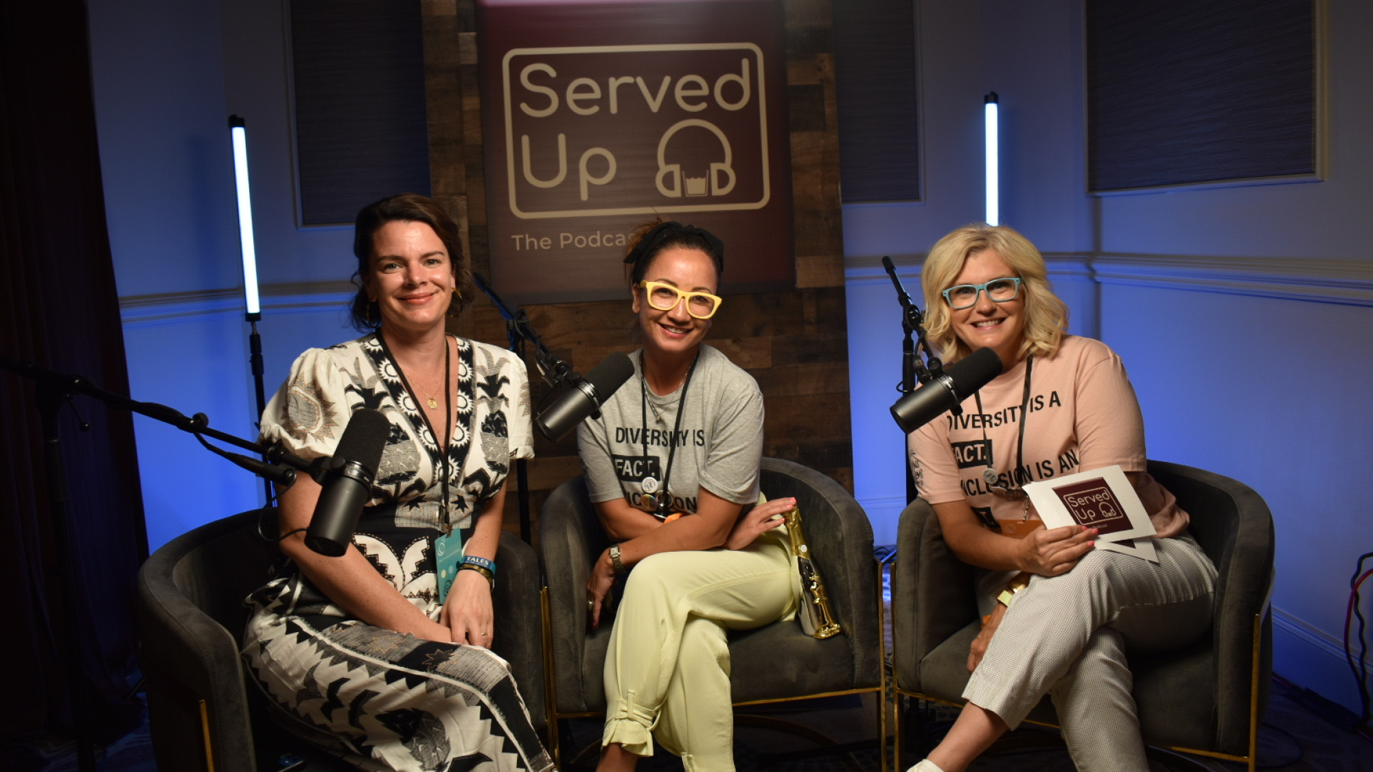 Three women seated with microphones in a podcast studio with a backdrop that includes the Served Up podcast logo.